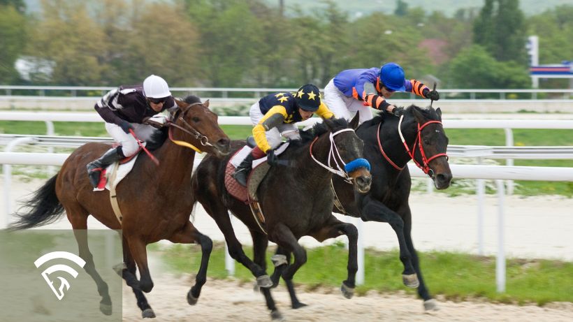 Horses racing on a dirt track