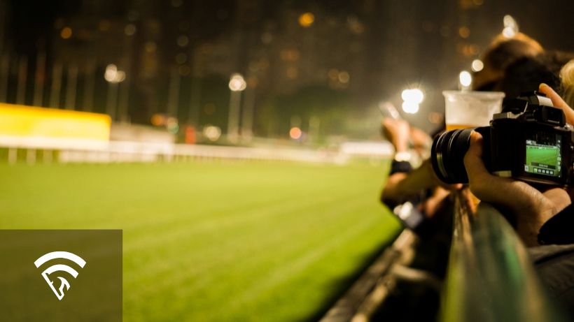 Horse racing track with bystanders and photographers