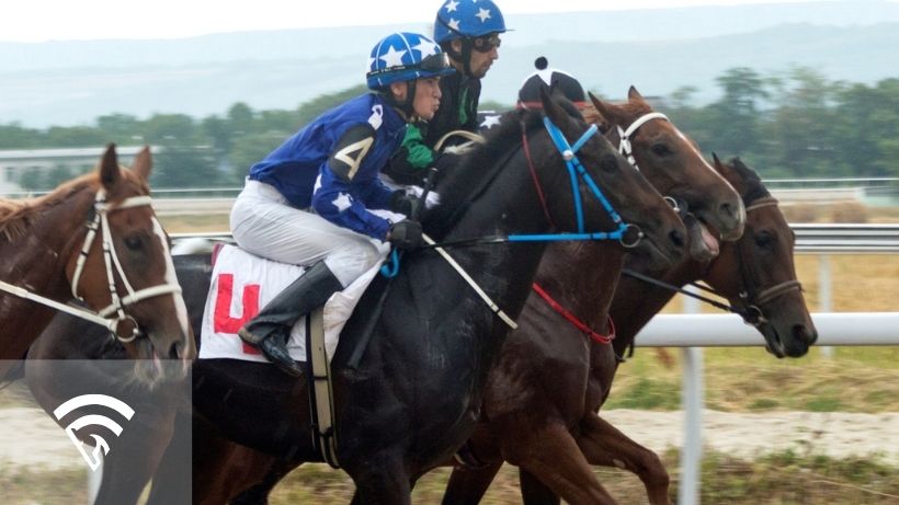 Close up of horses and jockeys racing representing the topic of past performance abbreviations in horse racing
