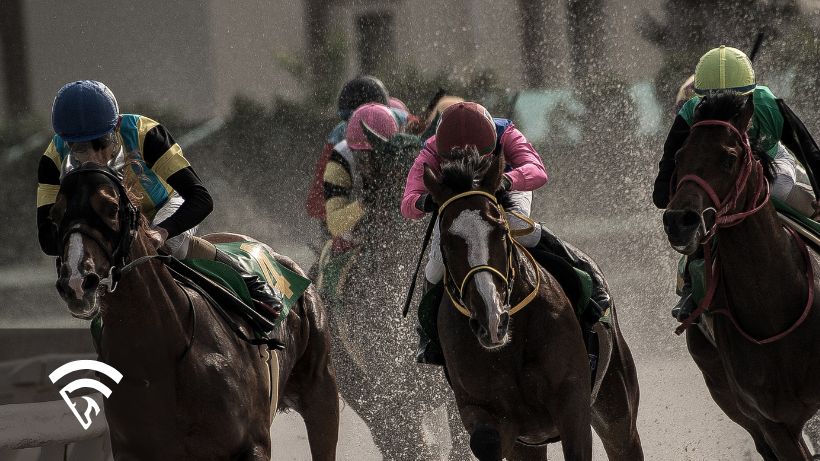 Close up of horses and jockeys racing